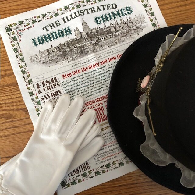 Photo of program, top hat, and gloves for post on the Great Dickens Christmas Fair